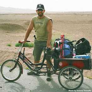 Antonio Graceffo with his cycle rickshaw filled with gear crossing 
the Taklamakan Desert